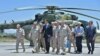 Syrian President Bashar al-Assad (center) visits the Russian air base at Hmeimim on June 27.