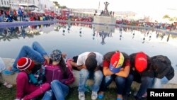 Venezuelans rest as they wait for a chance to view the body of President Hugo Chavez lying in state at the military academy in Caracas on March 8.