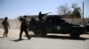 Afghan security officers stand guard outside the residence of Faridoon Momand, an Afghan lawmaker, after a suicide bomb attack in Jalalabad on June 8.