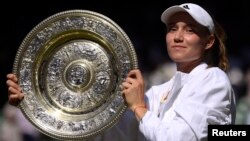 Kazakhstan's Elena Rybakina poses with the trophy after winning the women's singles final against Tunisia's Ons Jabeur on July 9.