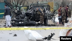 Afghan security forces inspect the site of a bomb blast in Kabul on February 20.