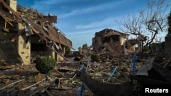 Residential buildings damaged during a Russian missile strike are seen in the Kyiv region on June 23.