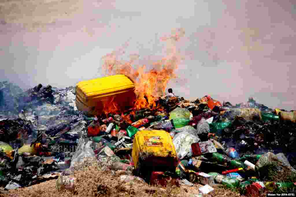 Afghan officials burn expired drug and food items in Helmand on June 23. (epa-EFE/Watan Yar)