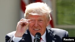 U.S. President Donald Trump refers to amounts of temperature change as he announces his decision that the United States will withdraw from the landmark Paris climate agreement at the White House in Washington, D.C., in June.