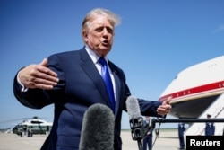 US President Donald Trump speaks to the media at Joint Base Andrews before boarding Air Force One for a trip to the Republican National Midterm Convention on September 9.