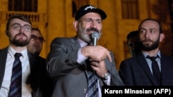 Armenian Prime Minister Nikol Pashinian (center) addresses supporters during a rally near the parliament building in Yerevan early on October 3.