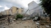 A man walks near damaged buildings in the aftermath of Israeli strikes on Beirut's southern suburbs on October 1.