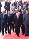 Chinese leader Xi Jinping walks with foreign leaders at a military parade in Beijijng on September 3. 
