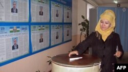 A woman casts her ballot at a polling station in Tashkent on March 29.