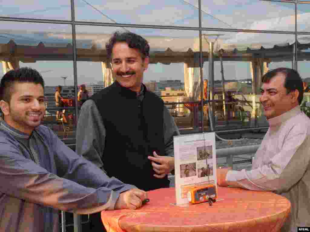 Radio Mashaal broadcaster and popular Pashtun folk singer Haroon Bacha and fellow musicians enjoy the view from the Newseum at RFE's 60th anniversary celebration in Washington, DC.