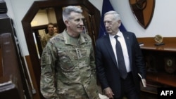 U.S. Defense Secretary James Mattis, right, and U.S. Army General John Nicholson, commander of U.S. Forces Afghanistan, arrive to meet with an Afghan defense delegation at Resolute Support headquarters in Kabul on April 24.