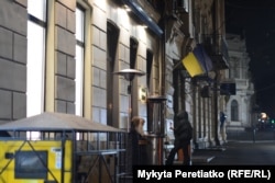 Women stand outside a restaurant in central Dnipro on December 11.