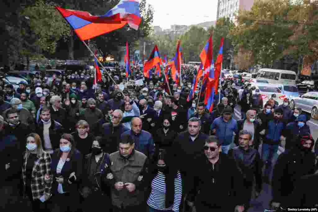 Protesters wave Armenian flags on the streets of Yerevan.