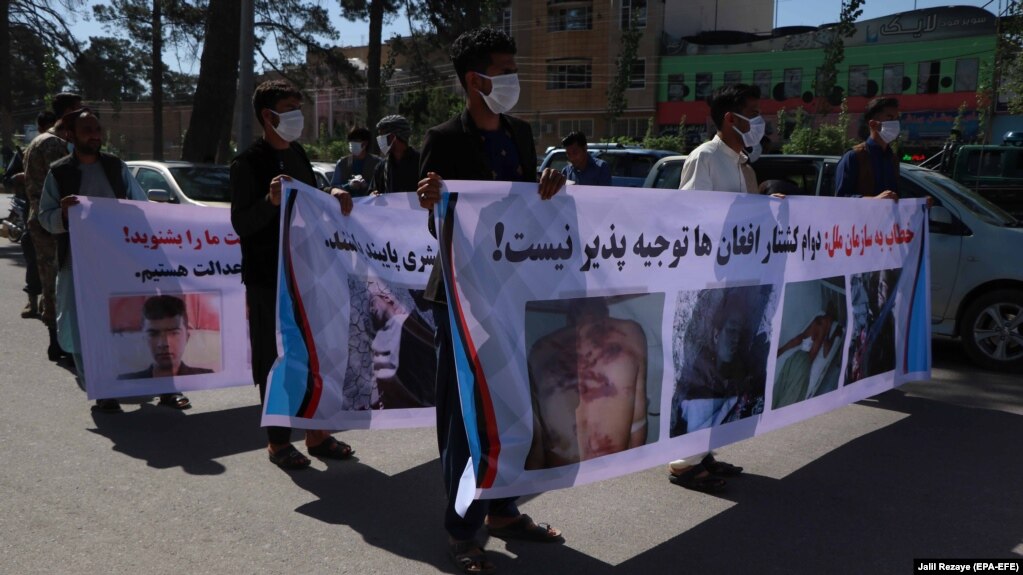 Afghans shout slogans outside the Iranian consulate in Herat on May 11 during a protest to demand justice for Afghans allegedly killed by the Iranian security forces.