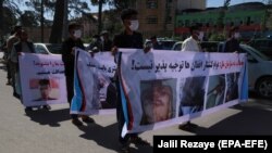 Afghans shout slogans outside the Iranian consulate in Herat on May 11 during a protest to demand justice for Afghans allegedly killed by the Iranian security forces.