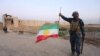 A member of Iraqi federal forces holds the Kurdish flag upside down in Kirkuk on October 16.