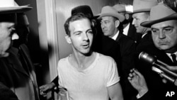 Experts had believed the new JFK files would reveal more about the movements of his presumed assassin, Lee Harvey Oswald (pictured), in the months before the killing took place in November 1963. (file photo)