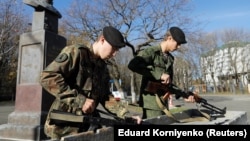 Students of the General Yermolov Cadet School assemble a Kalashnikov assault rifle and a machine gun during a demonstration lesson marking Mikhail Kalashnikov's 100th anniversary of birth in Stavropol on November 8.