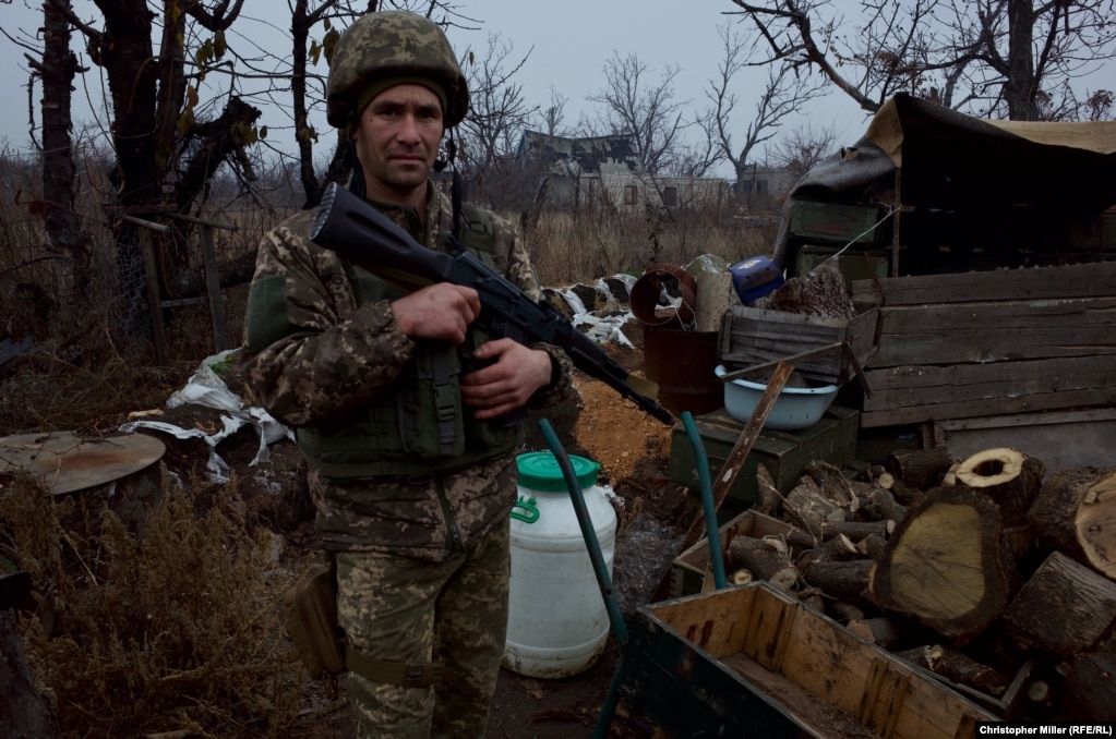 A soldier stands guard at the front line in the industrial city of Avdiyivka.