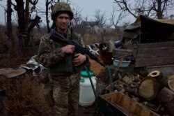 A soldier stands guard at the front line in the industrial city of Avdiyivka.