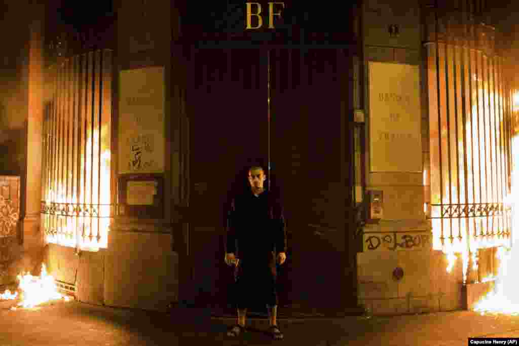 Russian artist Pyotr Pavlensky poses in front of a Banque de France building after setting fire to the window gates as part of a performance in Paris on October 16. (AP/Capucine Henry)