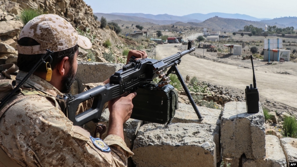 A Taliban security officer waits along a road near the Ghulam Khan border crossing between Afghanistan and Pakistan in Khost Province on October 20.