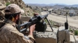 A Taliban security officer waits along a road near the Ghulam Khan border crossing between Afghanistan and Pakistan in Khost Province on October 20.