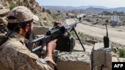 A Taliban security officer waits along a road near the Ghulam Khan border crossing between Afghanistan and Pakistan in Khost Province on October 20.