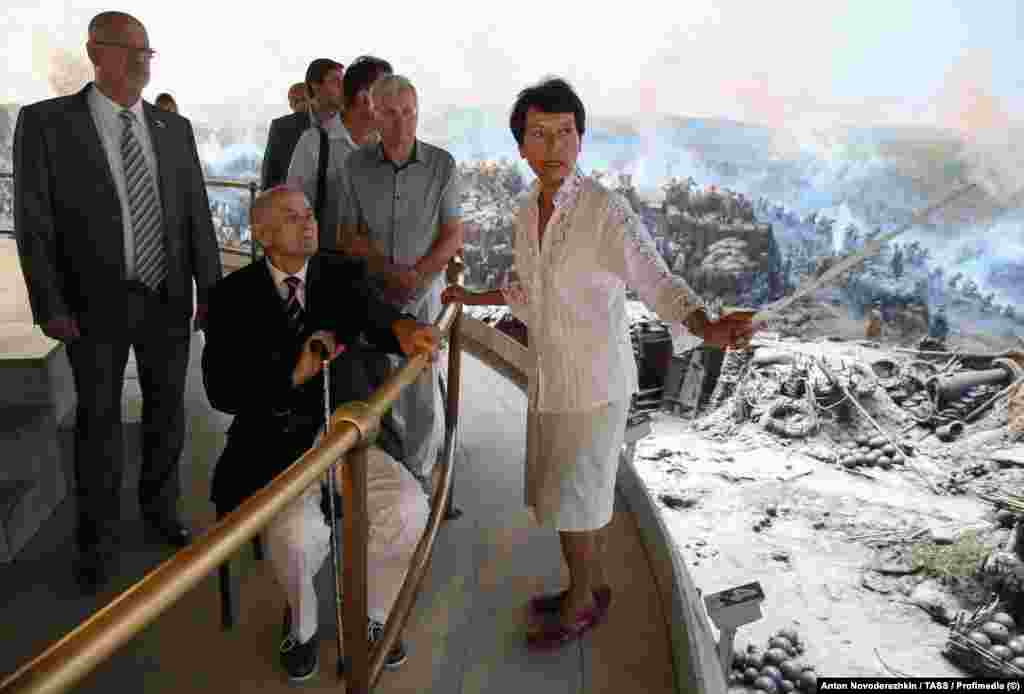Visitors being shown the panorama in Sevastopol in August 2015.The artwork was first painted in the early 1900s by the Russian-French artist Franz Roubaud, but the original was largely destroyed during the Nazi-led invasion of the Soviet Union. Its surviving remnants were evacuated by sea from Sevastopol in 1942 and stored at an unspecified location.