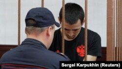 Anarbek Chingiz attends a court hearing on his detention in Moscow on June 18.