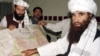 Jalaluddin Haqqani (right), the Taliban's minister for tribal affairs, points to a map of Afghanistan as son Nasiruddin, who was killed in Islamabad earlier this month, looks on during a 2001 visit to Islamabad.