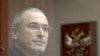 Russia -- Jailed Russian former oil tycoon Mikhail Khodorkovsky stands behind a glass wall before the start of a court session in Moscow, October 28, 2010.