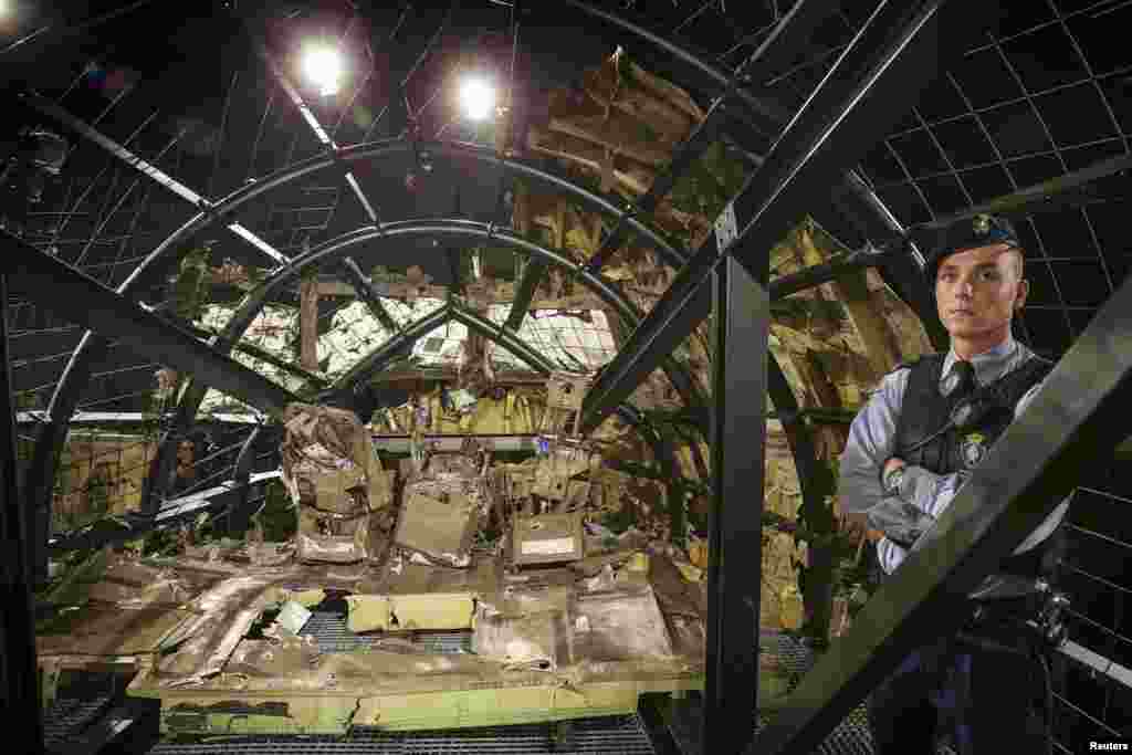 A military policeman stands guard inside the reconstructed cockpit of Malaysia Airlines flight MH17 during the presentation of the final report by the Dutch Safety Board into the cause of the crash at the Gilze-Rijen Air Force base in the Netherlands. The plane was shot down over eastern Ukraine by a Russian-made Buk missile, the Dutch Safety Board said, killing all 298 aboard. (Reuters/Michael Kooren)