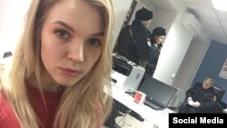 Изъятие полицией агитлистовок в красноярском штабе Навального (на фото волонтер штаба Анна), февраль 2018