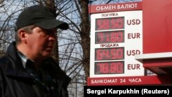 RUSSIA -- A board with the currency exchange rates of the U.S. dollar and the Euro against the Russian rouble is on display outside a bank branch in Moscow, April 10, 2018