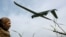 FILE PHOTO: A Ukrainian servicemember looks at a reconnaissance drone as it launches from a position near the front line at an undisclosed location in southern Ukraine on an undisclosed date in 2026.