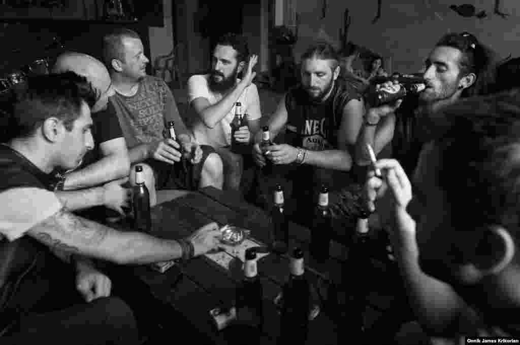 A group of Polish bikers enjoy a beer with the Cross Riders at their bar and clubhouse. They ​rode in to Tbilisi from Amsterdam to raise money for disabled children.