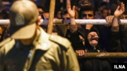 An Iranian woman cries at the scene of a public execution in Iran.