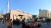 People take selfies in Plovdiv with a painted Trabant. The East German car is on display as part of Art Liberty, a traveling exhibition marking the 30th anniversary of the fall of the Berlin Wall.