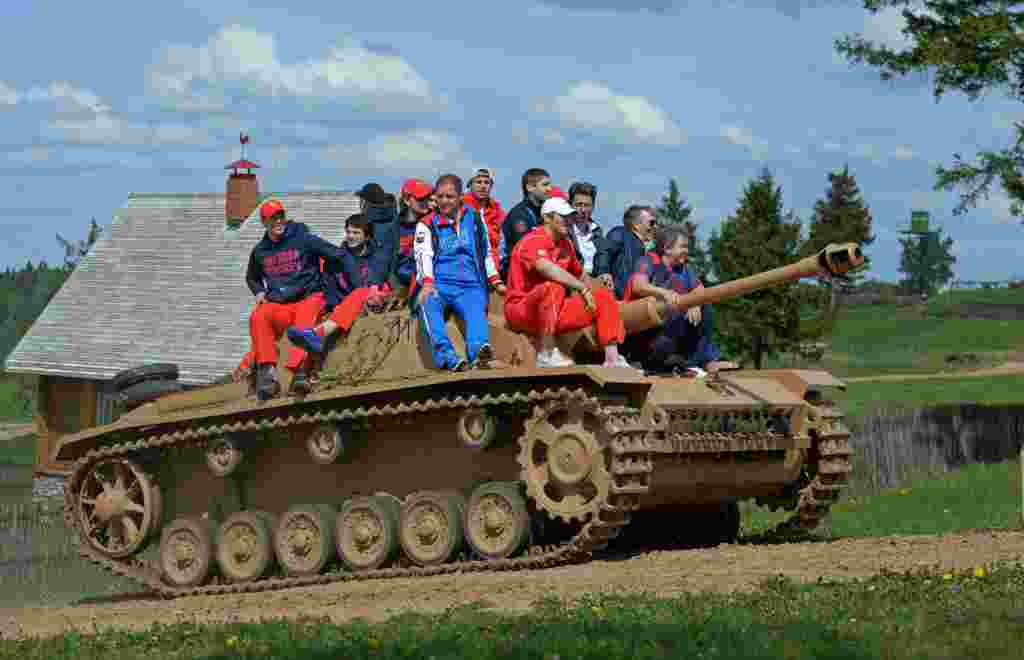 The Russian national ice-hockey team sits atop a tank during their visit to the Military History Museum of the Great Patriotic War near Minsk on May 15. (RIA Novosti/Grigory Sokolov)