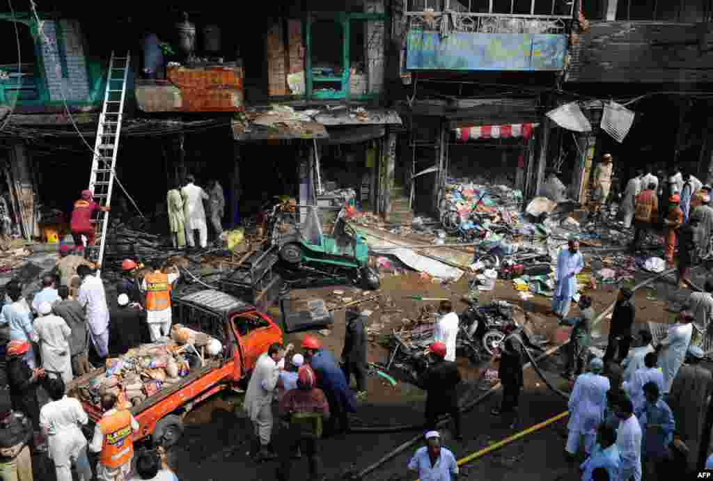 Security officials and rescue workers at the blast site.  