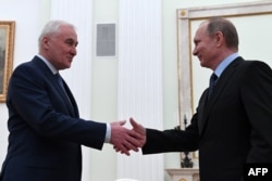 Russian President Vladimir Putin (right) meets with South Ossetia's Leonid Tibilov at the Kremlin in Moscow on March 21.