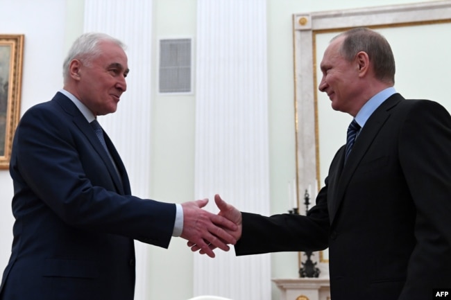Russian President Vladimir Putin (right) meets with South Ossetia's Leonid Tibilov at the Kremlin in Moscow on March 21.