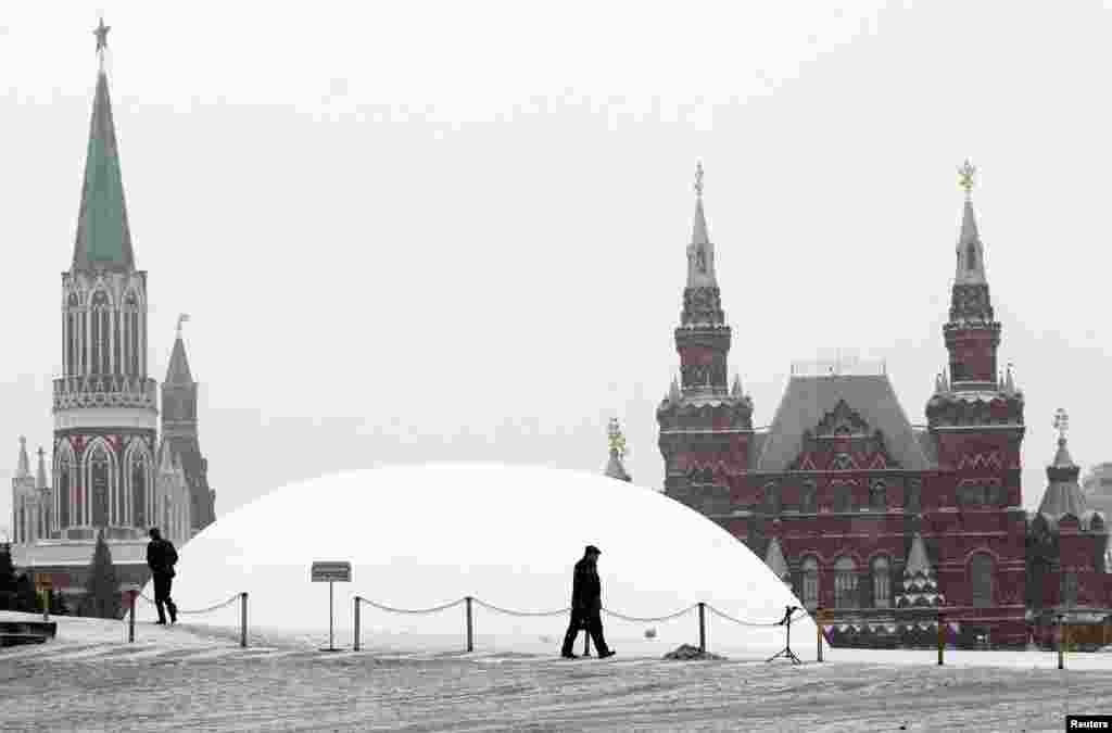 A temporary white dome covers the mausoleum of Vladimir Lenin on Red Square in Moscow. The mausoleum was closed for planned repairs and renovation work. Lenin's body will remain inside. (Reuters/Mikhail Voskresensky)