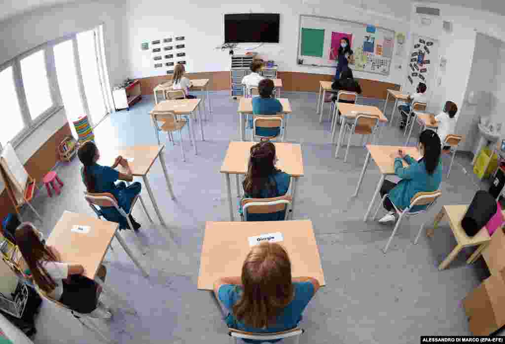 Students keep their distance in a class at the World International School of Turin on September 1. Ahead of the official start date of September 14, Italian schools are opening early for catch-up classes for students who fell behind in their studies during the pandemic.