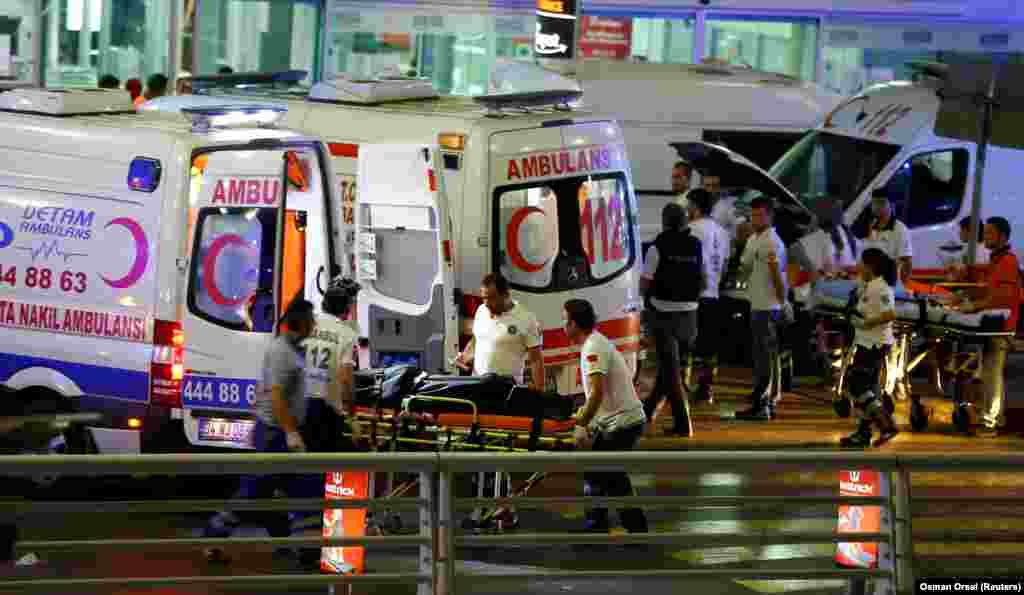 Paramedics help a man in a wheelchair at Turkey's largest airport, Istanbul Ataturk, Turkey, following a blast