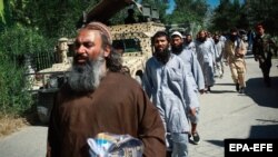 Taliban prisoners walk in line before their release from Bagram prison in the northern province of Parwan on May 26.