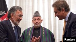 Pakistani Foreign Minister Shah Mahmood Qureshi (right) and his Afghan counterpart Zalmai Rassoul exchange signed agreements in Islamabad in March.