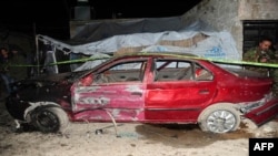 A destroyed car is seen following an attack in the Kafr Sousa area, a southwestern suburb of the Syrian capital, Damascus, on January 13.