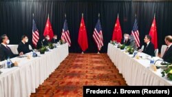 U.S. Secretary of State Antony Blinken (second right) and national-security advisor Jake Sullivan (right) speak while facing Yang Jiechi (second left), a Politburo member and Chinese leader Xi Jinping’s most senior envoy, and Foreign Minister Wang Yi (left) at the opening session of U.S.-China talks in Alaska on March 18.
